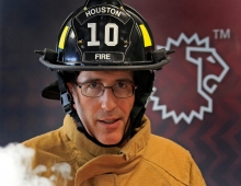 Steve Schwartz ’84 in firefighting gear with a smoke simulator.